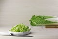 Whole and cut fresh ripe Chinese cabbage on table against white wooden background. Space for text Royalty Free Stock Photo