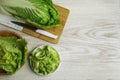 Whole and cut fresh ripe Chinese cabbage on white wooden table, flat lay. Space for text Royalty Free Stock Photo