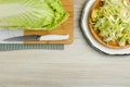 Whole and cut fresh ripe Chinese cabbage on white wooden table, flat lay Royalty Free Stock Photo