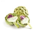 Whole and Cut Globe Artichokes on White Background