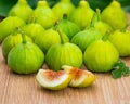 Whole and cut green figs, with fig leaves. Royalty Free Stock Photo