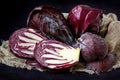 Whole And Cut In Half Fresh Red Cabbage In A Wooden Plate on Dark Background Royalty Free Stock Photo