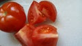 Whole & cut red tomatoe wedges -white background Royalty Free Stock Photo