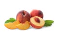 Whole and cut ripe peaches with leaves isolated Royalty Free Stock Photo