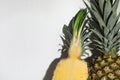 Whole and cut ripe pineapples on white background, closeup. Space for text Royalty Free Stock Photo