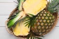 Whole and cut ripe pineapples on white wooden table, top view Royalty Free Stock Photo