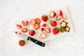 Whole, Cut, Sliced, Quartered and Halved Strawberries on Marble Chopping Board Royalty Free Stock Photo