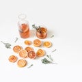 Whole and cut tangerines and blood oranges fruits. Thyme, mint herbs on wooden chopping board. White table background Royalty Free Stock Photo