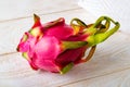 Whole dragon fruit or pitaya on a white wooden table. Fruits and vegetables. Healthy vegetarian food rich in B vitamins and tannin