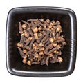 Whole dried cloves in black bowl isolated Royalty Free Stock Photo