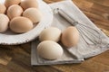 Whole eggs in bowl, whisk, napkin.