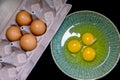 Whole eggs in carton cracked eggs bowl
