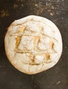 A whole English boule bread on distressed baking sheet