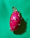 Ripe red fruit pitahaya isolated on a green background. Top view