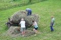 Family collects hay on a tractor, agricultural industry in Czech Republic
