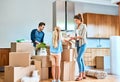 The whole family helping out in the house. a focused young family working together and unpacking boxes out in their new Royalty Free Stock Photo