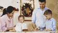 Whole family is making cookies together for Christmas. Royalty Free Stock Photo