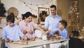 Whole family is making cookies together for Christmas. Royalty Free Stock Photo