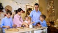 Whole family is making cookies together for Christmas. Royalty Free Stock Photo