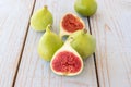 Whole figs and one fig sliced in half on top of a garden table Royalty Free Stock Photo