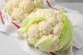 Whole fresh raw cauliflowers on white table, closeup