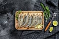 Whole fresh raw tiger prawns, shrimp on a wooden tray. Black background. Top view Royalty Free Stock Photo