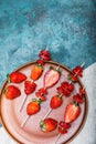 Whole fresh red strawberries and sliced strawberries on wooden skewers in ceramic plate Royalty Free Stock Photo