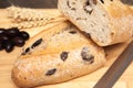 A whole freshly baked olive bread with loves and wheat Royalty Free Stock Photo