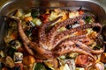 a whole freshly made octopus on griled vegetable bed in a restaurant in Rovinj Croatia