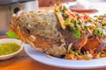 Whole fried snakehead fish, seasoned with chopped mango, lemongrass, chili, spring onions. Royalty Free Stock Photo