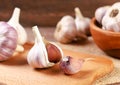 Whole garlic and clove of garlic on wooden background
