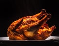 Steaming hot Rotisserie chicken for dinner against black background