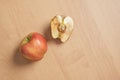 whole good and cut in half rotten apple on wooden background Royalty Free Stock Photo