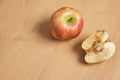 whole good and cut in half rotten apple on wooden background Royalty Free Stock Photo