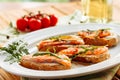 Whole grain bread with avocado paste and salmon decorated with arugula. Side close view with cherry tomatoes on Royalty Free Stock Photo