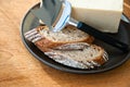 Whole grain bread, cheese, and knife on a plate Royalty Free Stock Photo