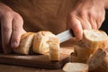 Man cutting fresh bread with a big knife Royalty Free Stock Photo