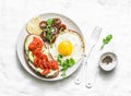 Whole grain bread, cream cheese, avocado, smoked salmon sandwich and fried egg - delicious breakfast, snack, brunch on a light bac Royalty Free Stock Photo