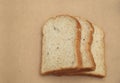 Whole grain bread on natural brown texture background. Royalty Free Stock Photo