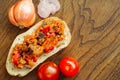 Whole grain bread, with roasted eggplant and tomatoes, onion on natural wood background. Sandwich or Bruschetta With