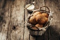 Whole grain bread rolls in a basket on a rustic wooden background. Royalty Free Stock Photo