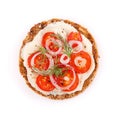 Whole grain bread sandwich with tomatoes and onion, seasoned with black pepper