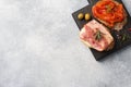 Whole grain bread sandwiches with cream cheese, bacon and canned peppers with tomato on a wooden cutting Board. Gray concrete Royalty Free Stock Photo