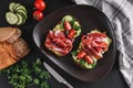 Whole grain bread sandwiches with prosciutto, avocado, cucumber, tomatoes