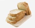 Whole grain bread slices on wooden cutting board Royalty Free Stock Photo