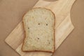 Whole grain bread on wood plate and brown texture background Royalty Free Stock Photo