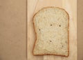 Whole grain bread on wood plate and brown texture background Royalty Free Stock Photo