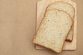 Whole grain breads on wood plate and brown texture background Royalty Free Stock Photo