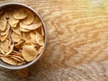 Whole grain corn flakes close-up in bowl on wooden background with copy space, useful breakfast Wholemeal Cornflakes