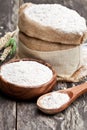 Whole grain flour in a wooden bowl and sackcloth bagwith ears Royalty Free Stock Photo